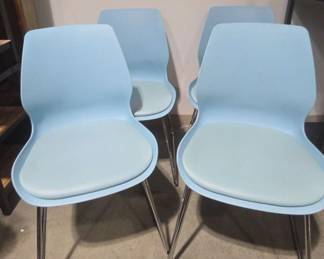 Four Blue Molded Chairs With Padded Seats And Chrome Legs
