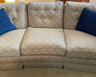 Beige Upholstered Couch With Blue Throw Pillows