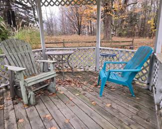 A wood and a plastic Adirondack chairs, small metal frame tables. All with vintage patina.