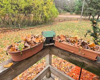 There are a number of plastic planters, some actually straddle the rail, also some potted plants.