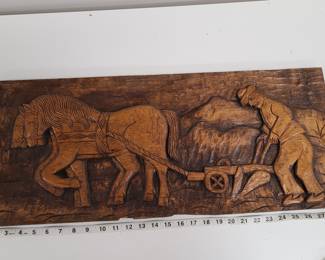 Carved wood panel plow scene