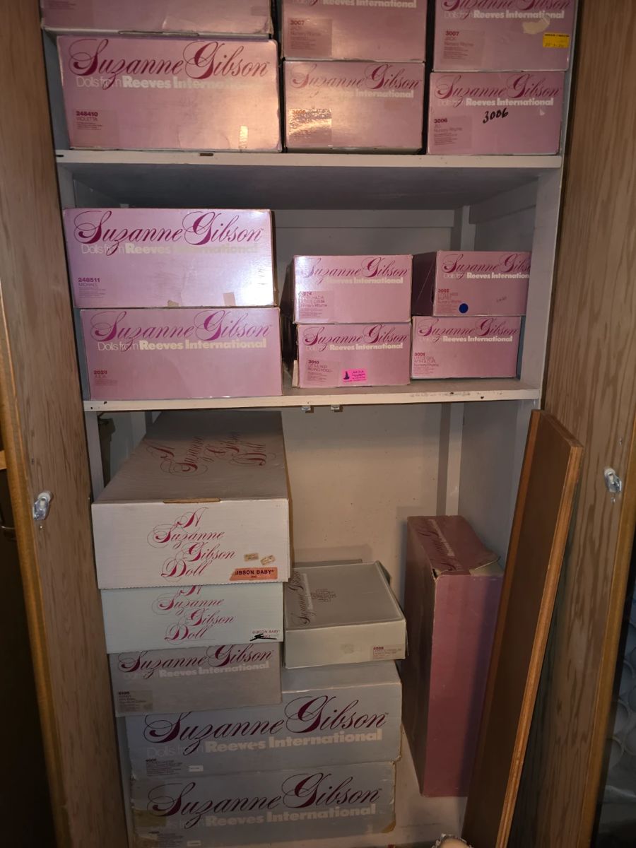 Basement closet full of Suzanne Gibson dolls, including two of the 1982 Mother Goose sets.