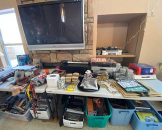 Two flat screen TVs, a surround sound system, DVDs, VHS, and more