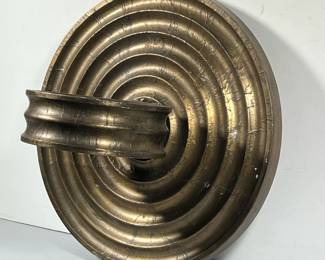 CONTEMPORARY FORMED METAL WALL SCONCE | Gold toned foil over carved composition layers, having concentric rings with a black velvet-lined (probably) votive holder. - h. 18 x w. 18 x d. 11 in