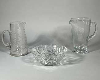 (3pc) TIFFANY & OTHER GLASS ITEMS | Including Tiffany & Co. "cracked ice" form bowl (h. 32.25 x dia. 9 in.), plus a blown and etched glass tapering pitcher, and a blown and etched glass pitcher with grape motif.