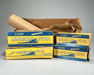 AMERICAN FLYER TRAIN SET IN ORIGINAL BOX | The A. C. Gilvert Co.: Gilbert American Flyer 3/16" scale trains, comprising rails, switch, and cars, including straight tracks, curve tracks, red car no. 638, log carrier no. 605, and locomotive 301 and Reading Lines car.
