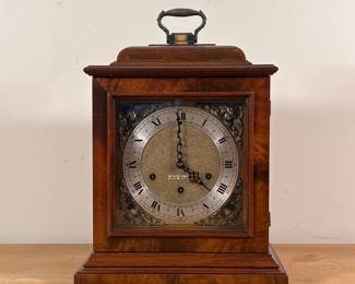 SETH THOMAS MANTEL CLOCK | Bracket form, Made in USA, the dial with Roman numerals, with applied corner decorations; with key - h. 13 x w. 10.75 x d. 7.5 in