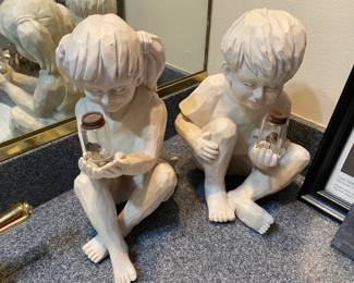Boy and girl garden sculptures.