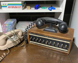 Princess phone and antique World War II era US Navy bakelite switch board phone.