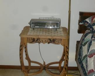 unusual table, clock radio, lamp