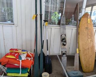 Canoe, life jackets, oars, surfboard, ski