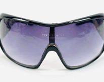 DOLCE & GABANNA Stylish Unisex Sunglasses With A Futuristic Oversized Wrap Design. The Lenses Are A Dark Purple Gradient And The Frames Are A Gloss Black.
