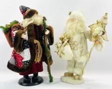 Two Exquisite Santa Claus Figures In Different Styles. One Features A Patchwork Coat And Wooden Staff, The Other A Glittering Gold Suit And Ornate Staff.
