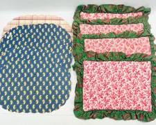 Lot Of 9 Vintage Pierre Deux Placemats In Two Styles. One Style Is Round With A Scalloped Edge In Navy Blue With A Yellow Design. The Second Style Is Rectangular And Quilted With A Pink Floral Pattern And Green Border.
