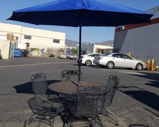 Lot # : 135 - Wrought iron patio set - table & 4 spring loaded
