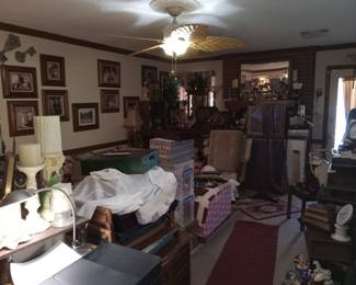 In the Living room there is lots of furniture, a sectional sofa, endtables, coffee table, multiple chairs, chests, bookcases, lamps, bins, covered boxes, storage, trays, rugs and yes even a ventriloquist dummy!!