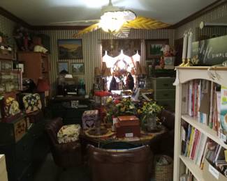 Dining room has an octagon shaped table with four rolling leather chairs