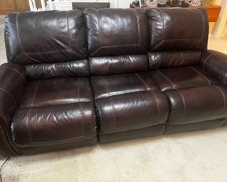 Brown leather couch with electric recliners on each end