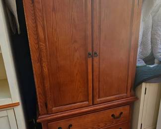 Media cabinet with accordion hinges.