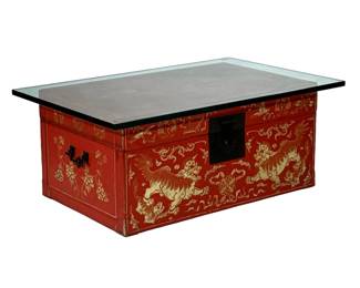 CHINESE GILT LEATHER BOX | The box with metal carrying handles and hardware, with allover gilt decoration with lions and scrollwork, having a glass top for use as a low table / coffee table. - h. 14 x l. 31 x d. 19.5 in (box only)