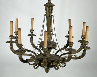 TEN LIGHT BRASS CHANDELIER | With faux candle electrified lights, scroll arms, decorated with chased garland and an acorn-form finial. - h. 32 x dia. 29 in