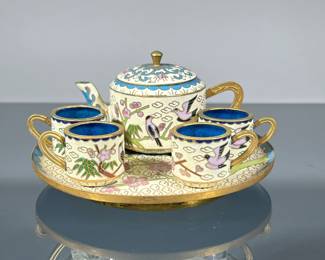 CHINESE MINIATURE CLOISONNE TEA SET | With blue, light yellow, and colored enamels, comprising a lidded teapot and four cups on a matching round tray. -  dia. 4.75 in (tray)