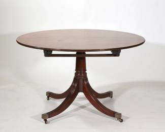 REGENCY STYLE PEDESTAL BREAKFAST TABLE | Round top table with inlaid wood border, over four reeded legs terminating in brass capped feet, with leaves. -  h. 29 x dia. 48 in (without leaves)