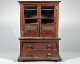 MINIATURE STEP BACK CUPBOARD | Mahogany Cupboard with two doors over two drawer. - h. 16.25 x w. 5.5 x l. 11.75 in