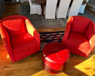 Two red upholstered chairs with matching ottoman