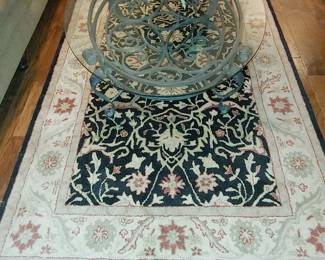 Oval Glass Coffee Table, Black and Tan Floral Area rug