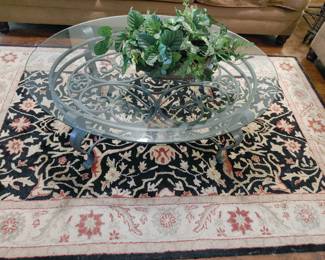 Oval Glass Coffee Table, Black and Tan Floral Area rug