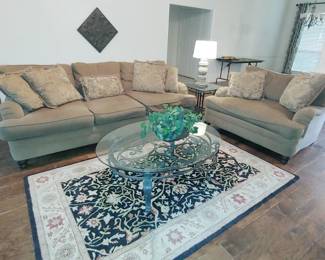 Tan Chenille Sofa and Love Seat, Oval Glass Coffee Table, Black and Tan Floral Area rug with matching runner