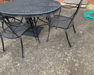 #132 Black Wrought Iron Oval Table w/4 Chairs - 38x60 Table has a base for umbrella $120.00