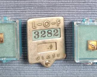 Vintage Libbey Owens Ford service pins and badge