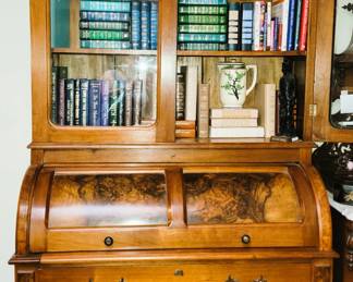 Burled wood antique roll-top cabinet with secretary. Colorful leather Readers Digest books