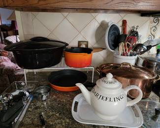 Le Creuset Dutch Oven, orange pot and skillet, white tray. Copper Dutch oven