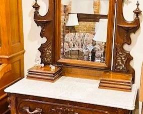 Victorian marble top dresser with attached ornate mirror. Available for immediate purchase