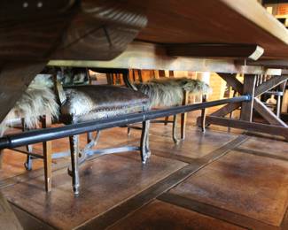 Massive iron pole from one end of table to the other.