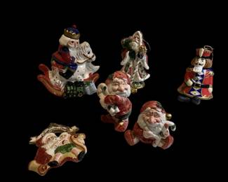 ROHU515 Have A Merry Fitz And Floyd Christmas Fitz and Floyd Salt and Pepper Santa Gnomes; Santa on a Rocking Horse; Santa from 1998 and a porcelain nutcracker bell with swivel head and dangling legs.
