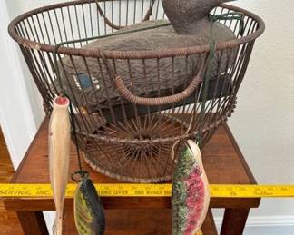 Duck decoy, a oyster basket and a string of wooden fish.