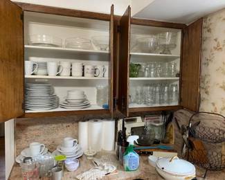 Dinnerware and  sets of clear drinking glasses ( samples on dining room )  