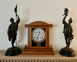 A pair of antique spelter  figures of Renaissance-dressed hunters standing on matching bases.