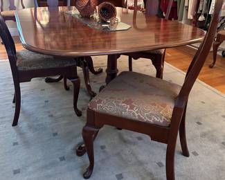 Queen Anne Extension Dining Table with 3-leaves and pads, 10-matching chairs, post-Modern wool area rug. 