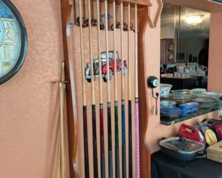 CUE STICKS  AND HOLDING RACK FOR THE POOL TABLE