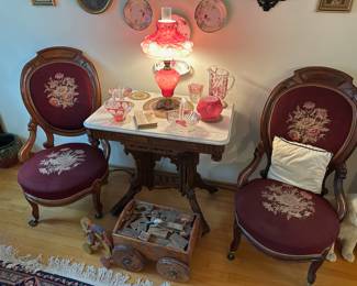 Victorian Style Side Table with White Marble Top, Pair of Victorian Medallion Back Parlor Chairs with Floral Needlepoint Upholstery, Satin Cranberry Glass Puffy Rose Hurricane Lamp, Circa 1930's Carved Wood Elephant Pool Toy, Early 1900's Children's Wagon for Building Blocks