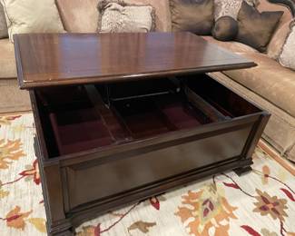 Coffee table with raising top