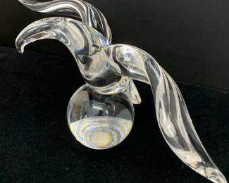 Lot # 48	$100.00	STEUBEN SOLID CRYSTAL GLASS EAGLE ON SPHERE	Height 6.75 in, width 12 in, depth 3.5 in. Poised as if to take flight, this hand-formed eagle balances atop a solid crystal sphere. The piece is signed Steuben and is c.1964. 	Bid at Woodardlipe.com or call 314-899-0098 for more information.