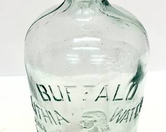 Lot # 7  	$25.00	BUFFALO LITHIA SPRINGS 19OO MINERAL WATER GLASS BOTTLE	"Height 10 in., diameter 4.5 in. Antique Buffalo Lithia Water Bottle
in light aqua glass with raised lettering. Buffalo Lithia Water (later Buffalo Mineral Springs Water) was a brand of lithia water bottled in Buffalo Lithia Springs, Virginia. It was advertised as able to treat fevers and nervous disorders and was sold from the late 19th century to the early 20th. At the height of its popularity, it was available in approximately groceries and pharmacies in Europe, Canada, and the United States."	Bid at Woodardlipe.com or call 314-899-0098 for more information.