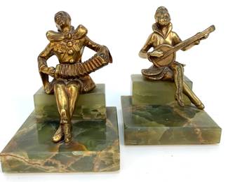 Lot # 11	$50.00	PAIR ART DECO CAST MUSICIANS ON GREEN ONYX 	Height 5.5 in., width 4.0 in., depth 4.0 in., Playful cast Art Deco metal musician figurines on matching mottled green onyx bases. Condition, Good, no significant wear on surface patination.  Slight chip to front corner of male musician with concertina.  Female figure with Zither, back base has been professionally restored. Both stone bases mitered .0125 in. on edge. 	Bid at Woodardlipe.com or call 314-899-0098 for more information.