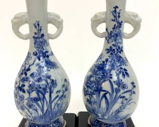 Lot # 16	$100.00	JAPANESE BLUE AND WHITE PORCELAIN HANDLED VASE, PAIR	Height 9 in, diameter 4 in. Pair of porcelain vases on wood stands, marked "Japan" feature an underglaze blue floral work with beast-head handles on either side. Wear consistent with age.	Bid at Woodardlipe.com or call 314-899-0098 for more information.